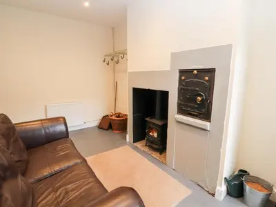 a living room with a couch and a fireplace at Cobbleken in Cockermouth
