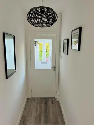 a hallway with a white door and a window at Mallaig in Rockcliffe
