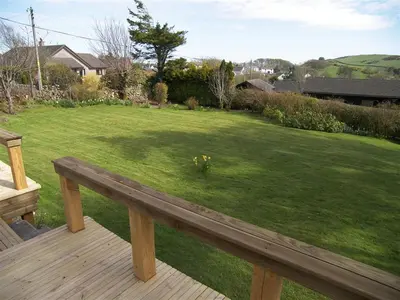 a wooden bench sitting on top of a yard at Mallaig in Rockcliffe
