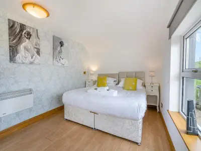 a bedroom with a large bed and a window at Ben Ma Cree in Portpatrick