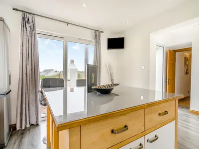 a kitchen with a counter and a large window at Ben Ma Cree in Portpatrick