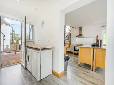 a kitchen with a washer and dryer in it at Ben Ma Cree in Portpatrick