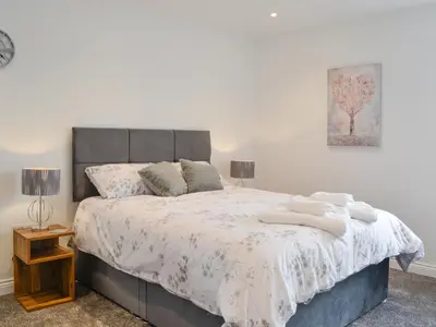 a bedroom with a large bed with two lamps at Old Byre Cottage - Uk43377 in Kirklinton