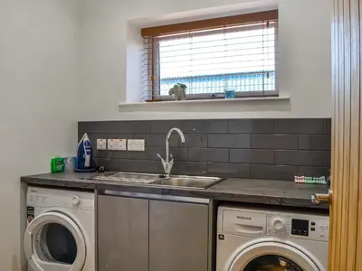 a kitchen with a sink and a washing machine at Fell View Cottage - Uk43378 in Kirklinton