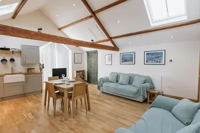 a living room with a couch and a table at ELM HOUSE BARN - Converted One Bed Barn at the gateway to the Lake District National Park in High Hesket
