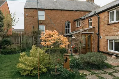 a house with a fire hydrant in the yard at ELM HOUSE BARN - Converted One Bed Barn at the gateway to the Lake District National Park in High Hesket