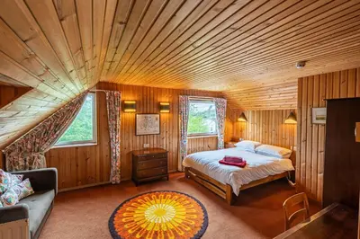 a bedroom with a bed and a large wooden ceiling at Bells View in Kippford