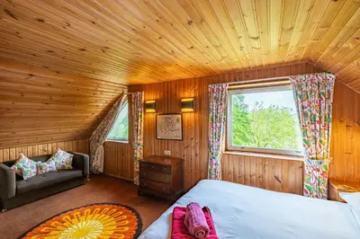 a bedroom with a bed and a window in a room at Bells View in Kippford