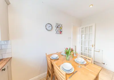 a kitchen and dining room with a wooden table at 7 Greta Grove House in Keswick