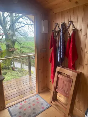 a wooden room with a door and a chair in it at Granny’s Hut in Thornhill