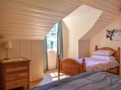 a bedroom with two beds and a window at Mossdale in Rockcliffe