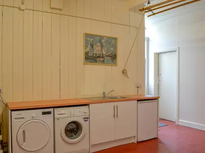 a kitchen with a sink and a washing machine at Mossdale in Rockcliffe