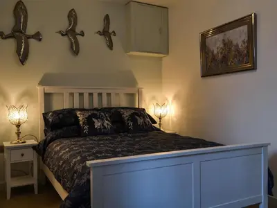 a bedroom with a bed and two antlers on the wall at Quayside7 in Whitehaven