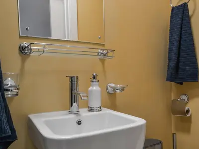 a bathroom sink with a soap dispenser on it at Quayside7 in Whitehaven