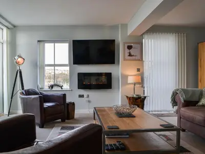 a living room with a couch and a table at Quayside7 in Whitehaven