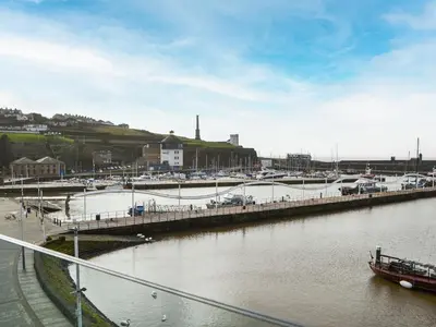 a marina with a boat in a body of water at Quayside7 in Whitehaven
