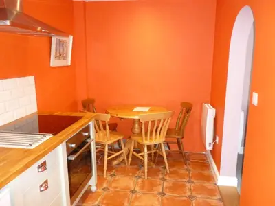 a small kitchen with a table and chairs at The Coach House, Hesket Newmarket in Hesket Newmarket