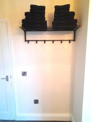 a room with a shelf with towels on it at Kirkcudbright Holiday Apartments - Apartment E in Kirkcudbright