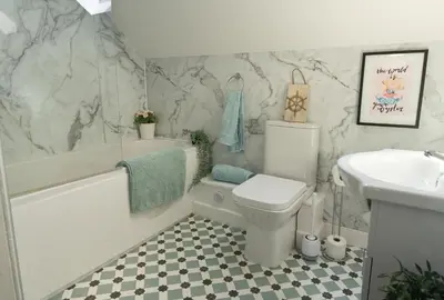 a bathroom with a toilet and a tub and a sink at The Portpatrick Pad - A cosy 3 bed cottage, w. sea views & garden office in Portpatrick
