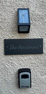a black appliance sitting on top of a wall at The Apartment, Bridge House in Laxey