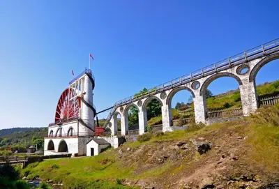 a bridge on top of a hill next to a mountain at The Apartment, Bridge House in Laxey