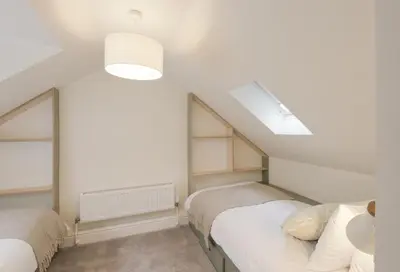 a attic bedroom with two beds and a skylight at Skerrow in New Galloway