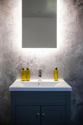 a bathroom sink with two yellow bottles on it at Kestrel Lodge 3 with Hot Tub in Newton Stewart