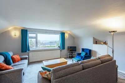 a living room with two couches and a window at Foxbrae Cottage in Rockcliffe
