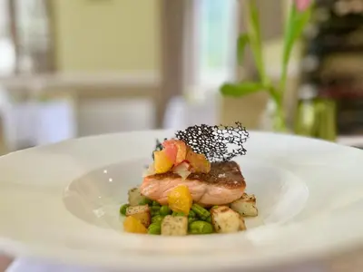 a plate of food with a piece of meat and vegetables at The Grasmere Hotel in Grasmere