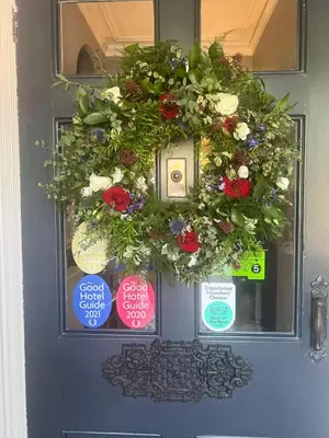 a wreath on a door with signs on it at The Grasmere Hotel in Grasmere