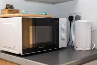 a microwave sitting on top of a kitchen counter at Cosy Glamping In the Eskdale Valley - Studio Lodges and Mega Pods in Eskdale