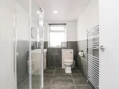 a bathroom with a toilet and a sink at Wainwright Cottage in Seascale