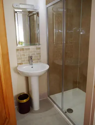 a bathroom with a sink and a shower at Rusko Stables in Gatehouse of Fleet