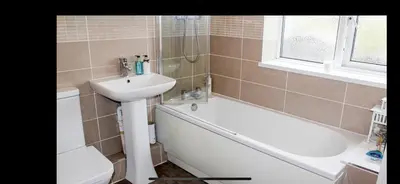 a bathroom with a sink and a tub and a sink and a toilet at Spacious Holiday Home in Cumbria in Arlecdon
