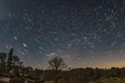 a starry night with a tree and star trails at Glamping Pod 2 Magical Craigengillan Estate in Dalmellington