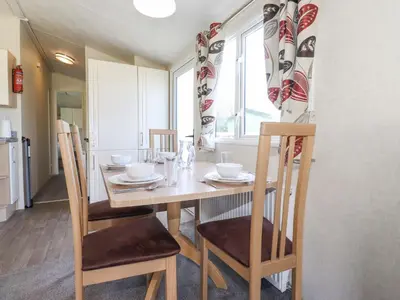 a kitchen and dining room with a table and chairs at Swinside in Cockermouth