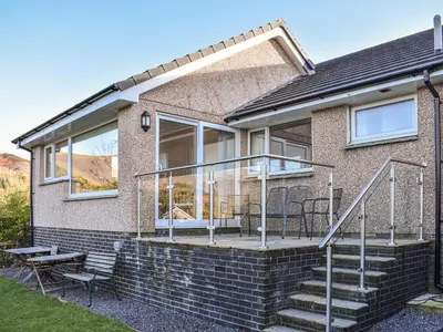 a brick house with a deck and a patio at Brow Riding in Keswick