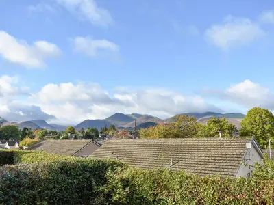 a group of roofs of houses with mountains in the background at Brow Riding in Keswick