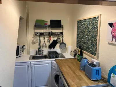 a kitchen with a washing machine and a sink at Bells yard Cottage Maryport in Maryport