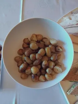 a white bowl filled with potatoes on a table at Eta's Manor @ Brooklands in Maryport