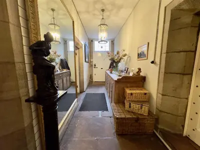 a hallway in a house with a statue of a woman at Calthwaite Hall Bed & Breakfast in Penrith