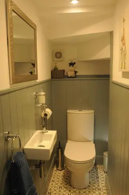 a bathroom with a white toilet and a sink at Serendipity in Kirkcudbright